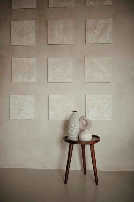 Luksusowe wnętrze salonu w stylu ekologicznym z beżowymi ścianami i balijskimi elementami przy naturalnym oświetleniu